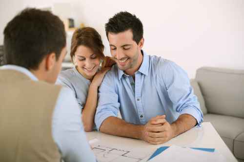 Young couple meeting architect for future house